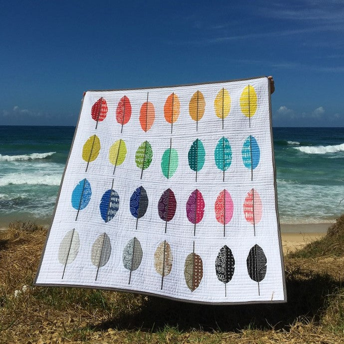 baby quilt made with rainbow paper pieced feathers