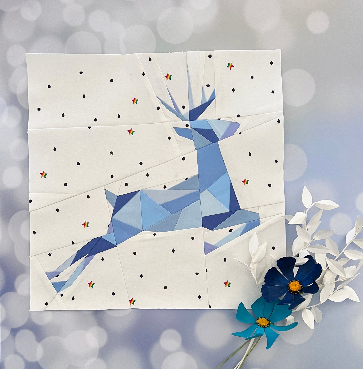 geometric reindeer foundation paper pieced pattern sewn in blue fabrics on a low volume background