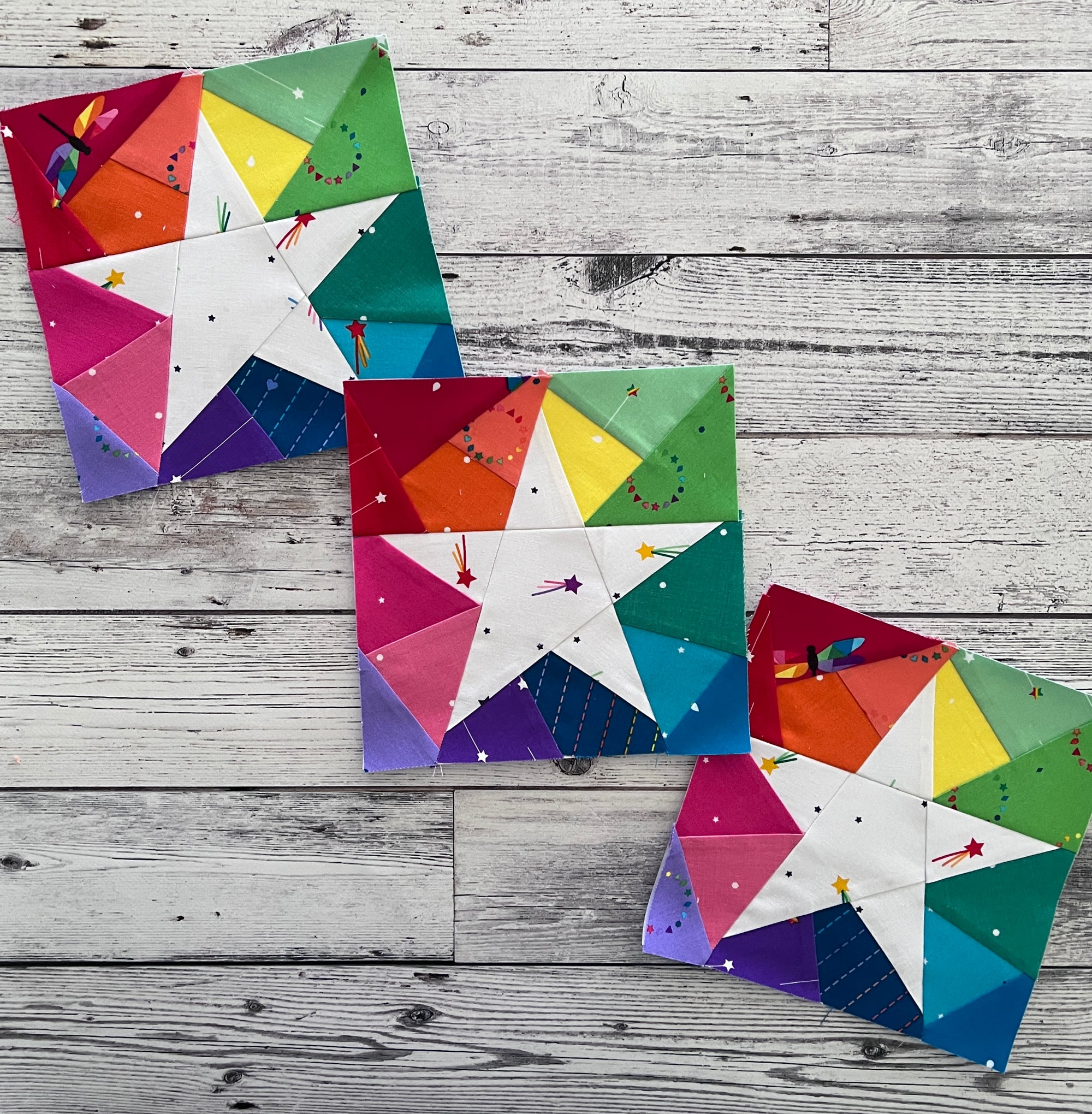 rainbow geometric star paper pieced pattern sewn in bright coloured fabrics