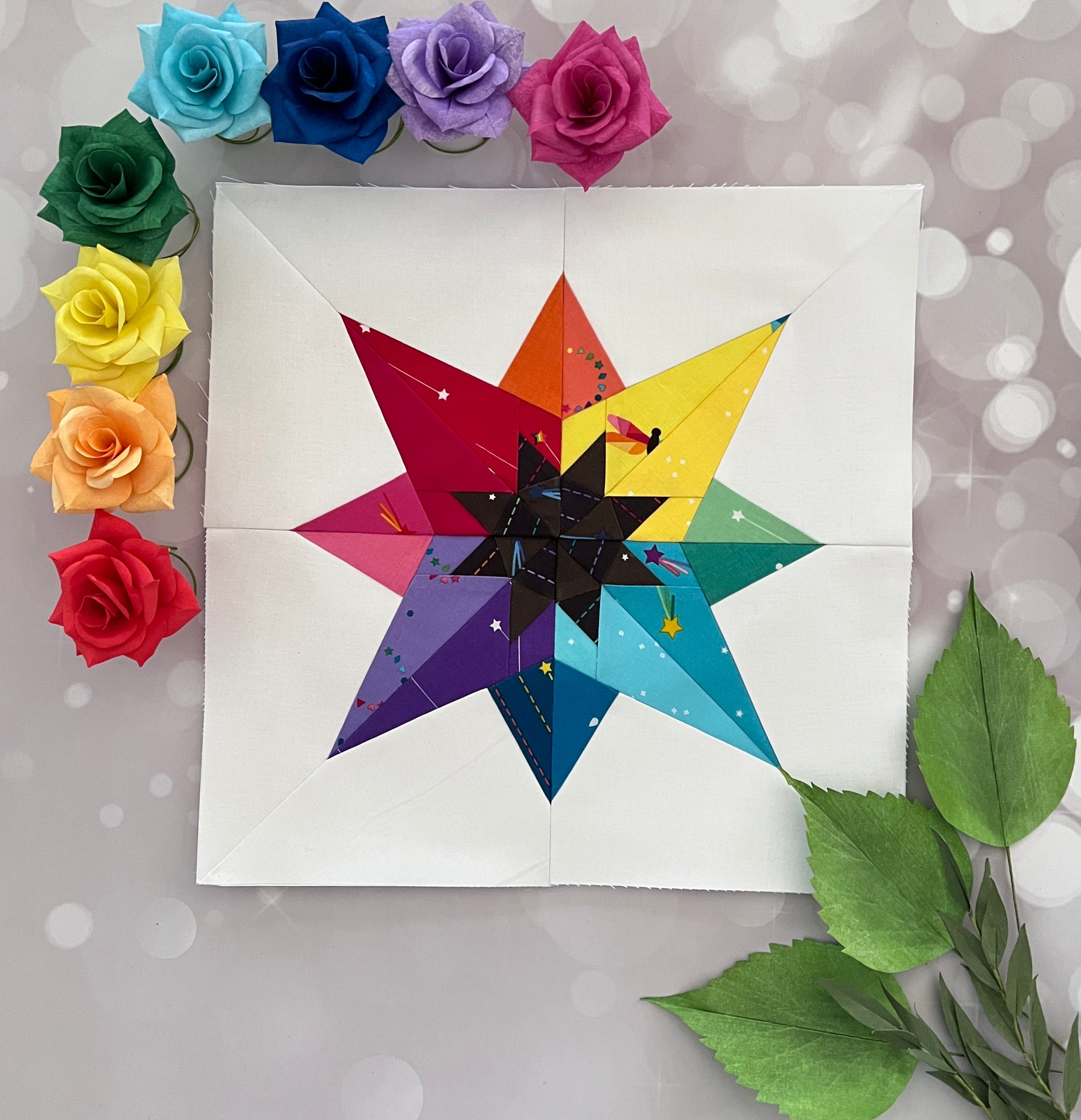 Glow paper pieced pattern sewn in rainbow fabrics