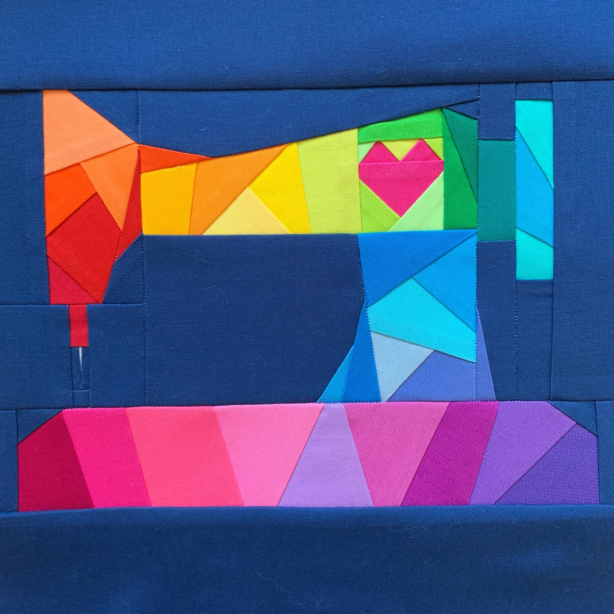 rainbow geometric sewing machine with a heart sewn in fabric