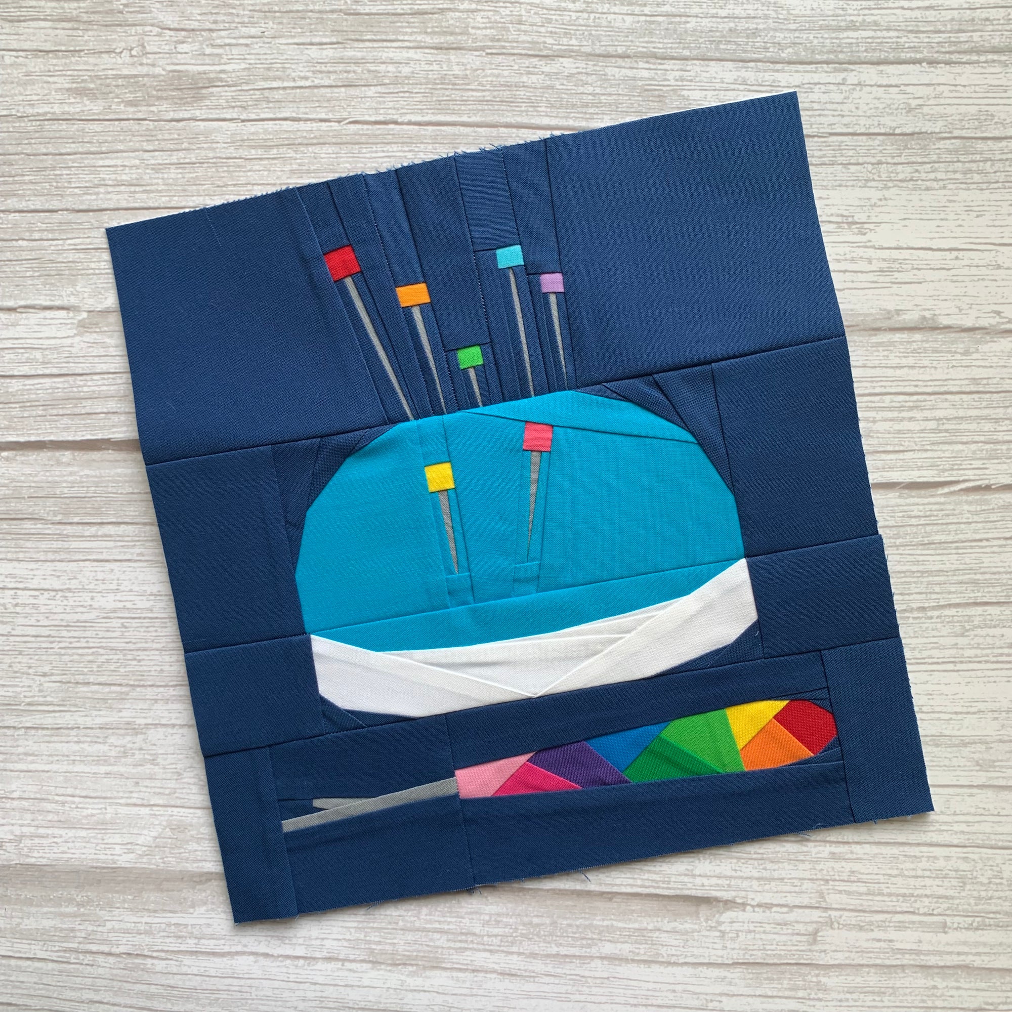 sewing notions paper pieced pattern with a pincushion, pins and seam ripper sewn in fabric
