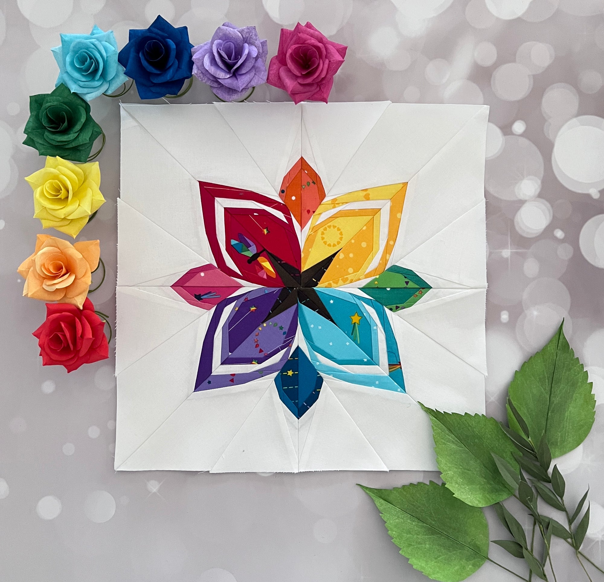 Stellar paper pieced pattern sewn in rainbow fabric