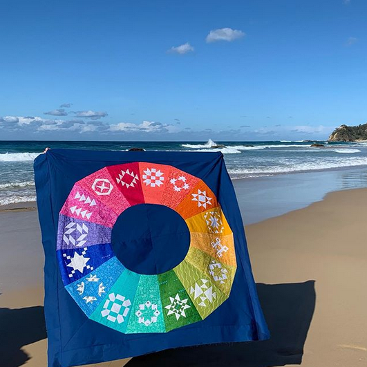 rainbow colour wheel Shades of Scotland paper pieced quilt pattern sewn in brightly coloured fabrics